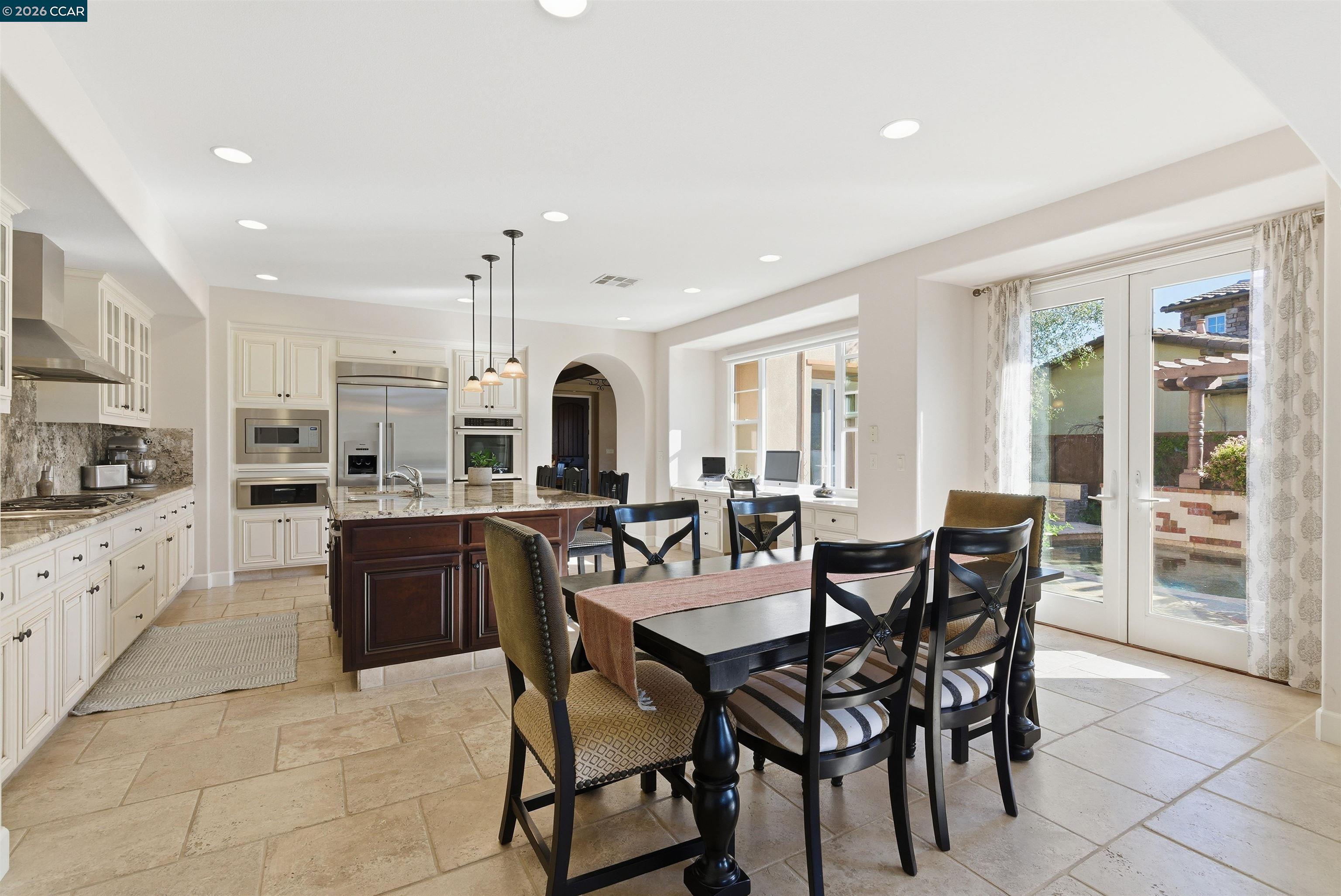 1041 South Wedgewood Road San Ramon, CA 94582 - Photo 15 of 33 a large kitchen with dining table chairs and granite counter tops