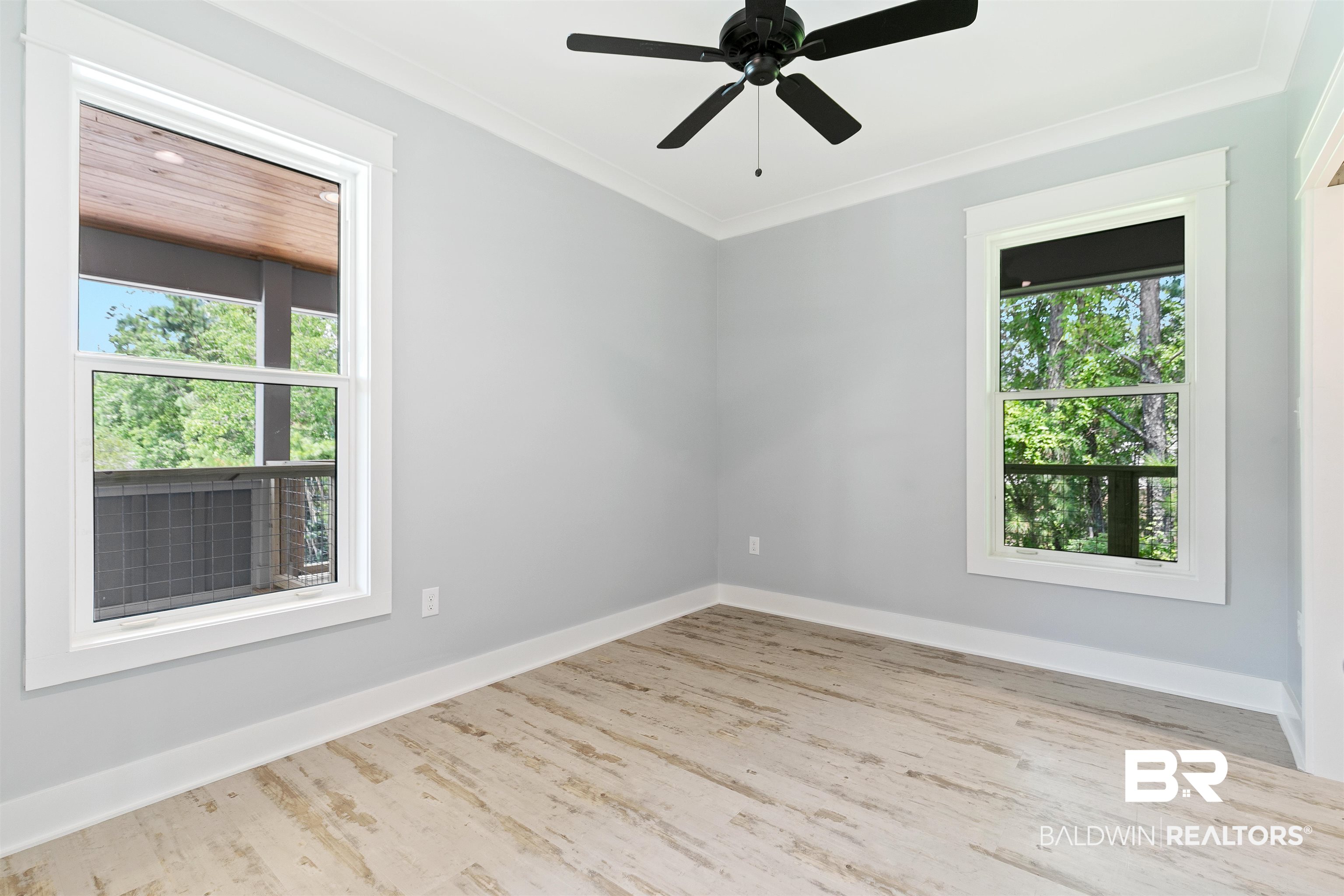 10507 County Road 1 Fairhope, AL 36532 - Photo 18 of 59 Empty room with ceiling fan, wood-type flooring, and ornamental molding