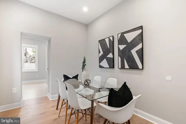a view of a hallway with wooden floor and entryway