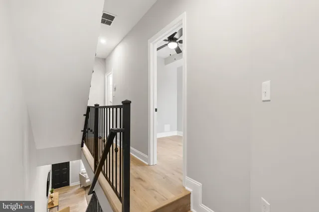 a living room with furniture and stairs