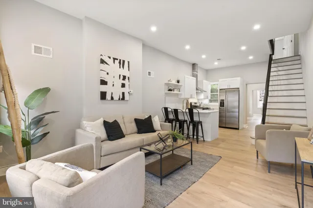 a living room with furniture and kitchen view