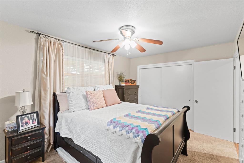 934 North Maple Street Muenster, TX 76252 - Photo 19 of 39 a bedroom with a bed and a chandelier