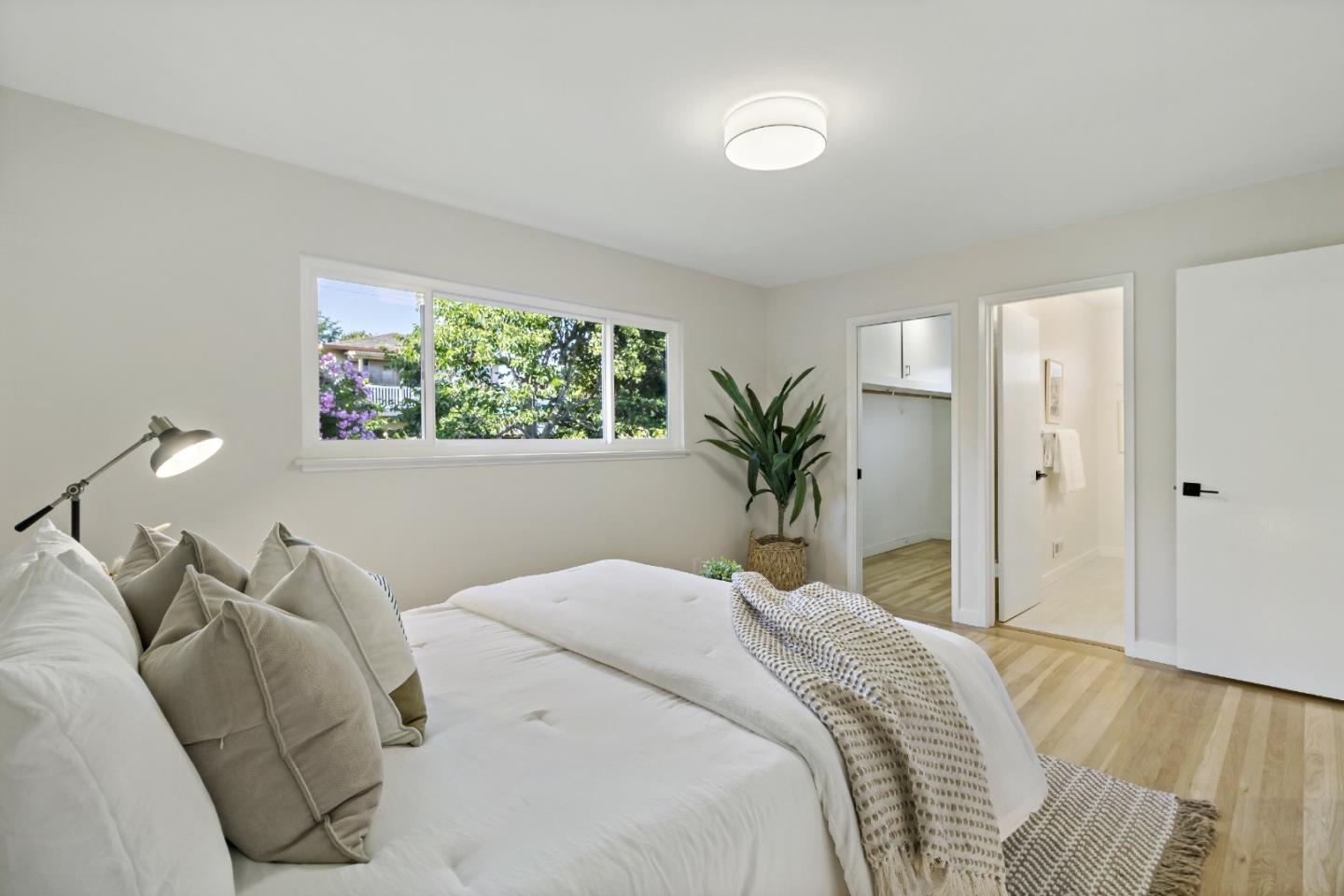 4825 Blue Ridge Drive San Jose, CA 95129 - Photo 16 of 39 a bedroom with a large bed and a potted plant