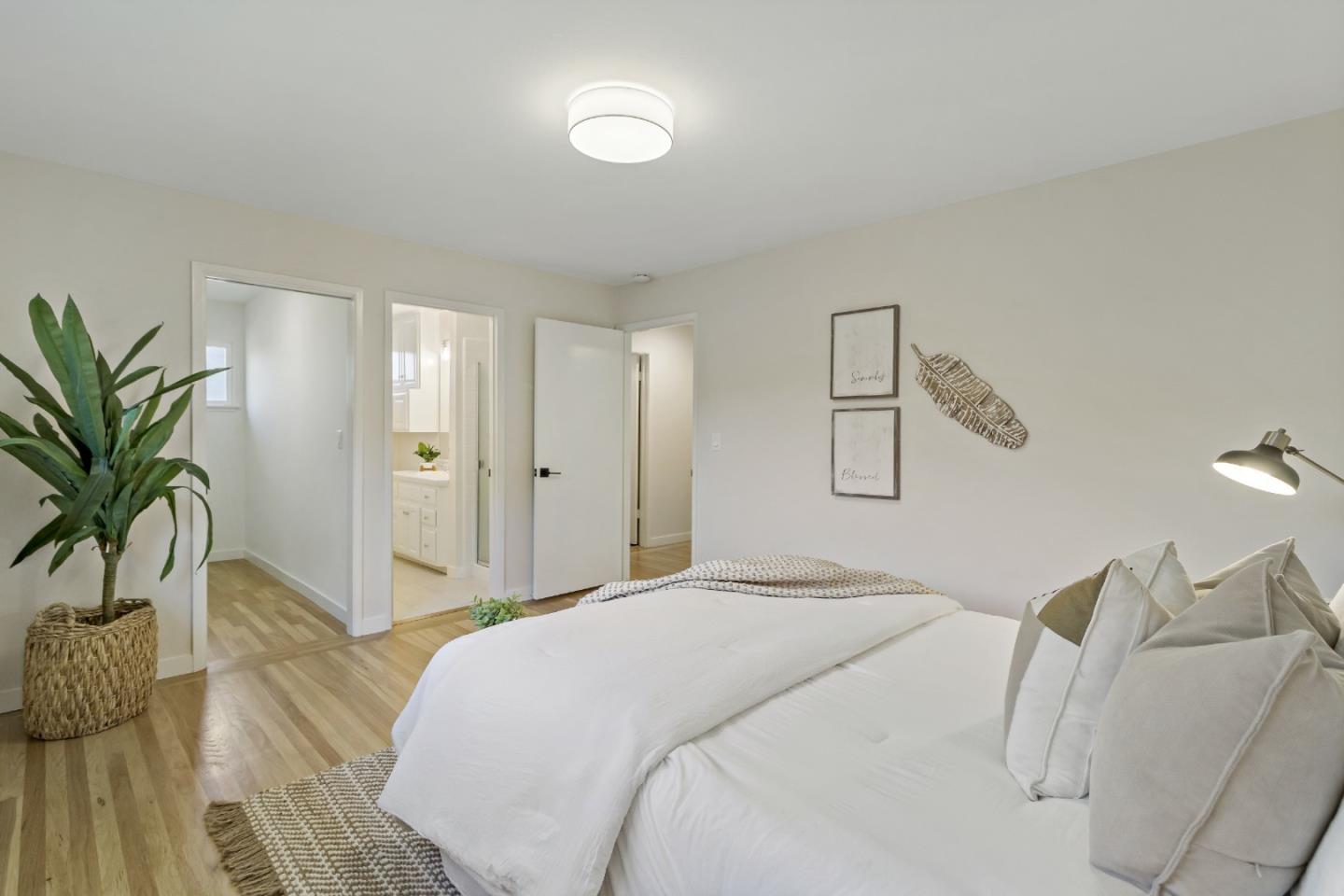 4825 Blue Ridge Drive San Jose, CA 95129 - Photo 17 of 39 a bedroom with a bed and a potted plant