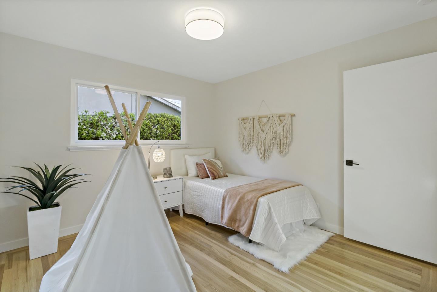 4825 Blue Ridge Drive San Jose, CA 95129 - Photo 25 of 39 a bedroom with a large bed and a large window