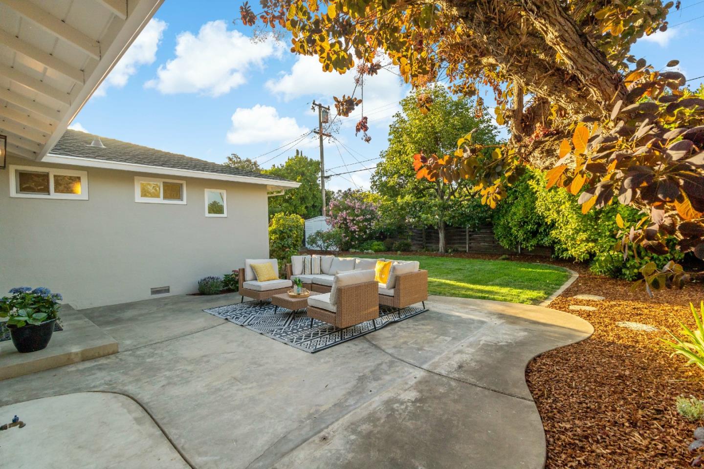 4825 Blue Ridge Drive San Jose, CA 95129 - Photo 27 of 39 a view of patio with a table and chairs under an umbrella