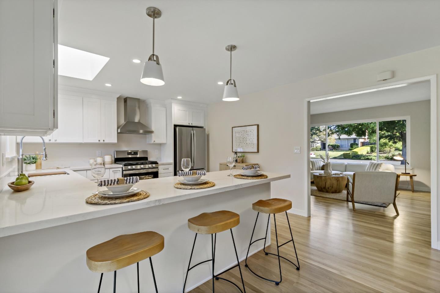 4825 Blue Ridge Drive San Jose, CA 95129 - Photo 5 of 39 a kitchen with stainless steel appliances granite countertop a stove a kitchen island a dining table and chairs with wooden floor
