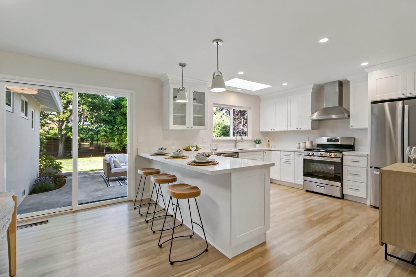 4825 Blue Ridge Drive San Jose, CA 95129 - Photo 6 of 39 a kitchen with kitchen island a large counter top space a sink stainless steel appliances and cabinets