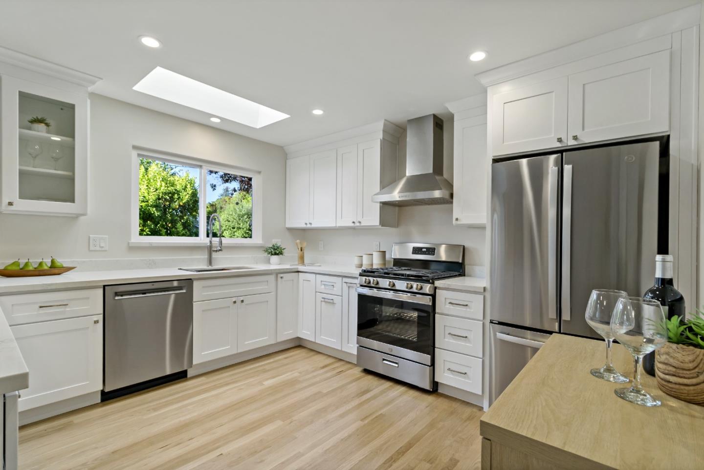 4825 Blue Ridge Drive San Jose, CA 95129 - Photo 7 of 39 a kitchen with stainless steel appliances granite countertop a stove a sink dishwasher a refrigerator and a oven with wooden floor