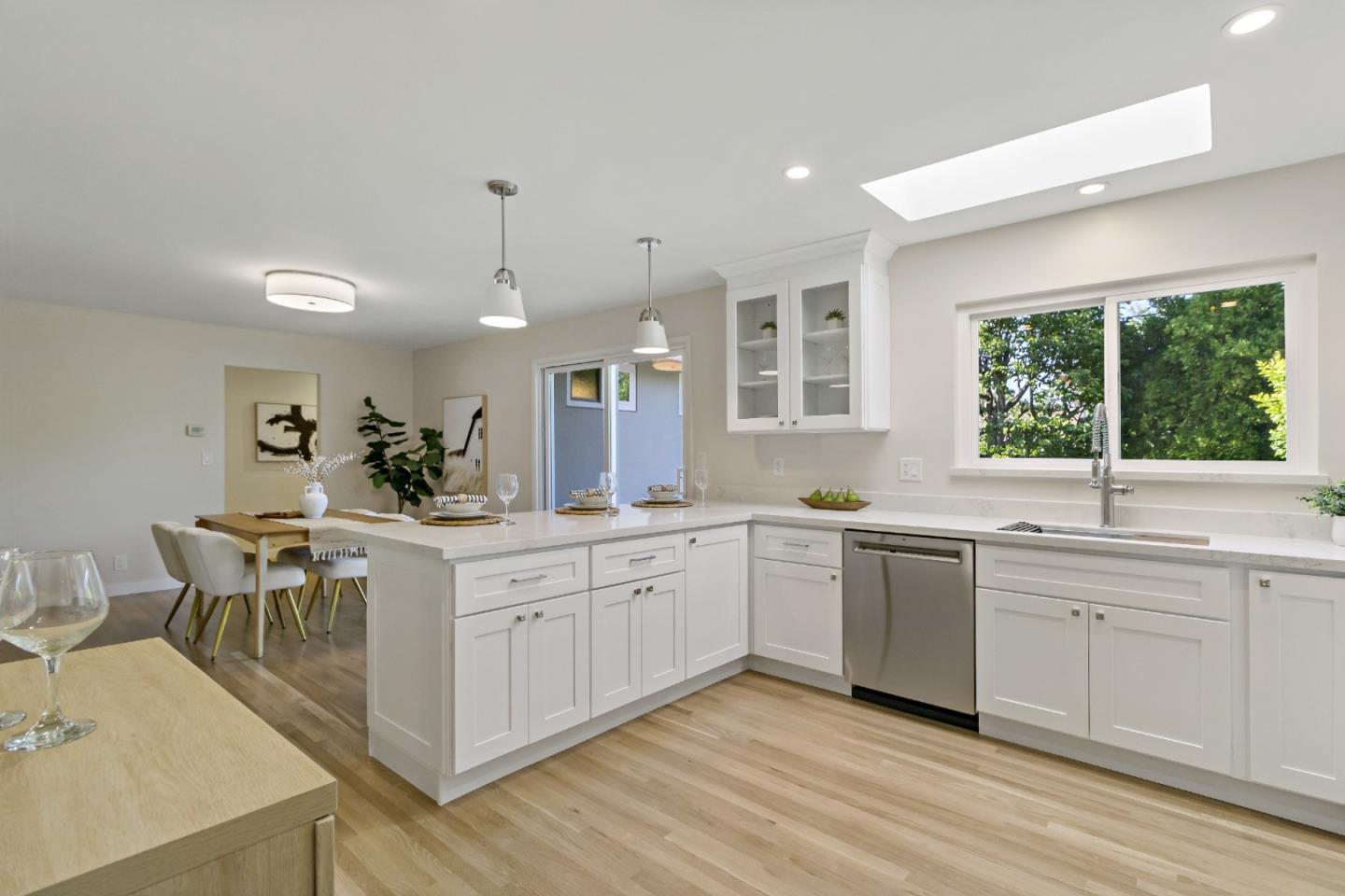 4825 Blue Ridge Drive San Jose, CA 95129 - Photo 8 of 39 a large white kitchen with sink and cabinets