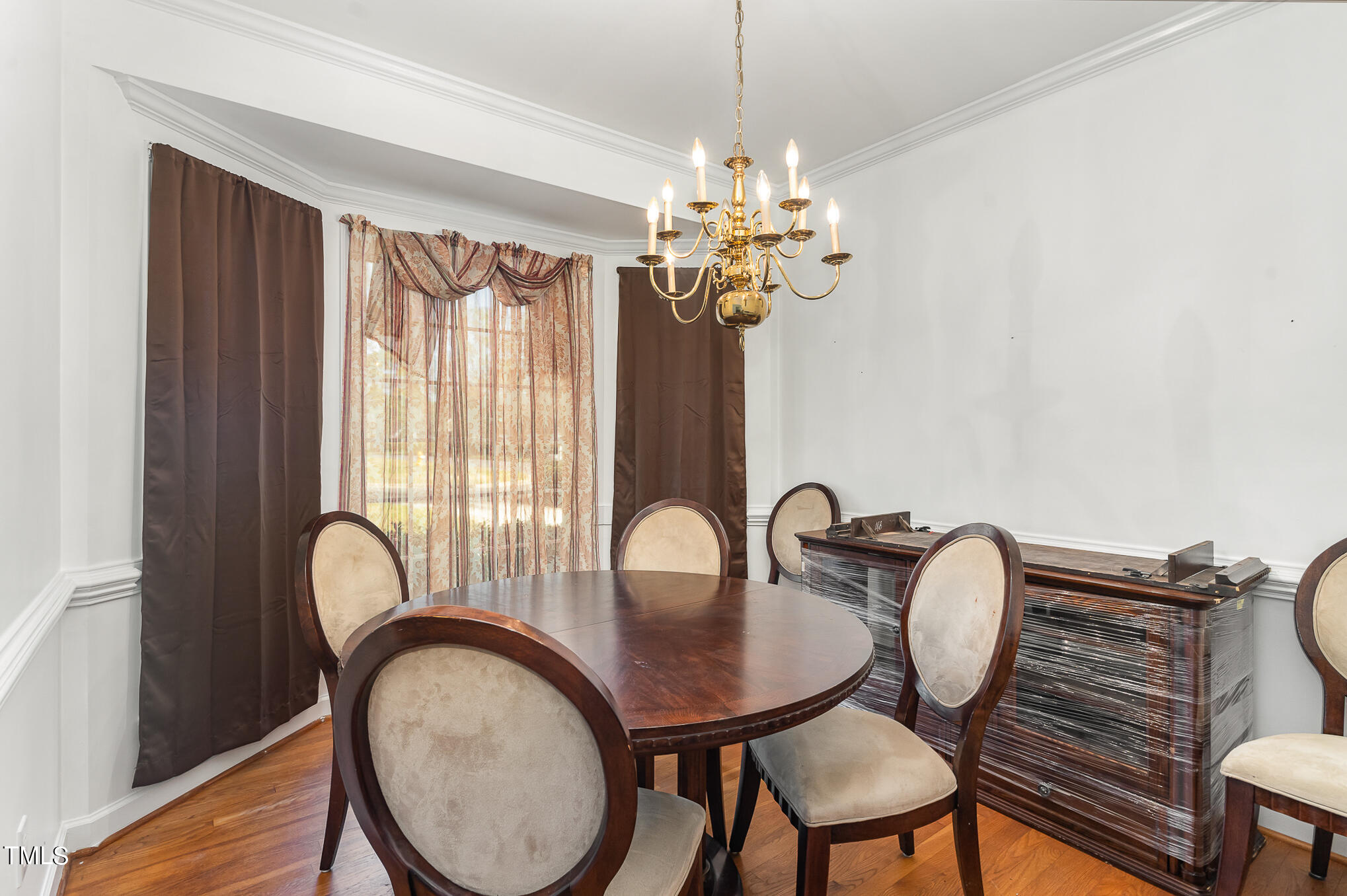 6020 Bur Trail Raleigh, NC 27616 - Photo 14 of 28 a view of a dining room with furniture window and wooden floor