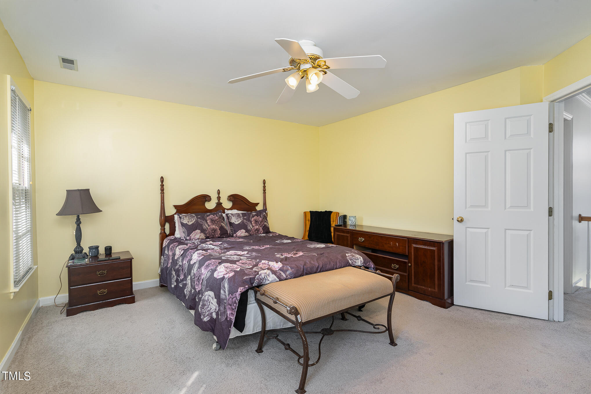 6020 Bur Trail Raleigh, NC 27616 - Photo 16 of 28 a bedroom with a bed and a chandelier