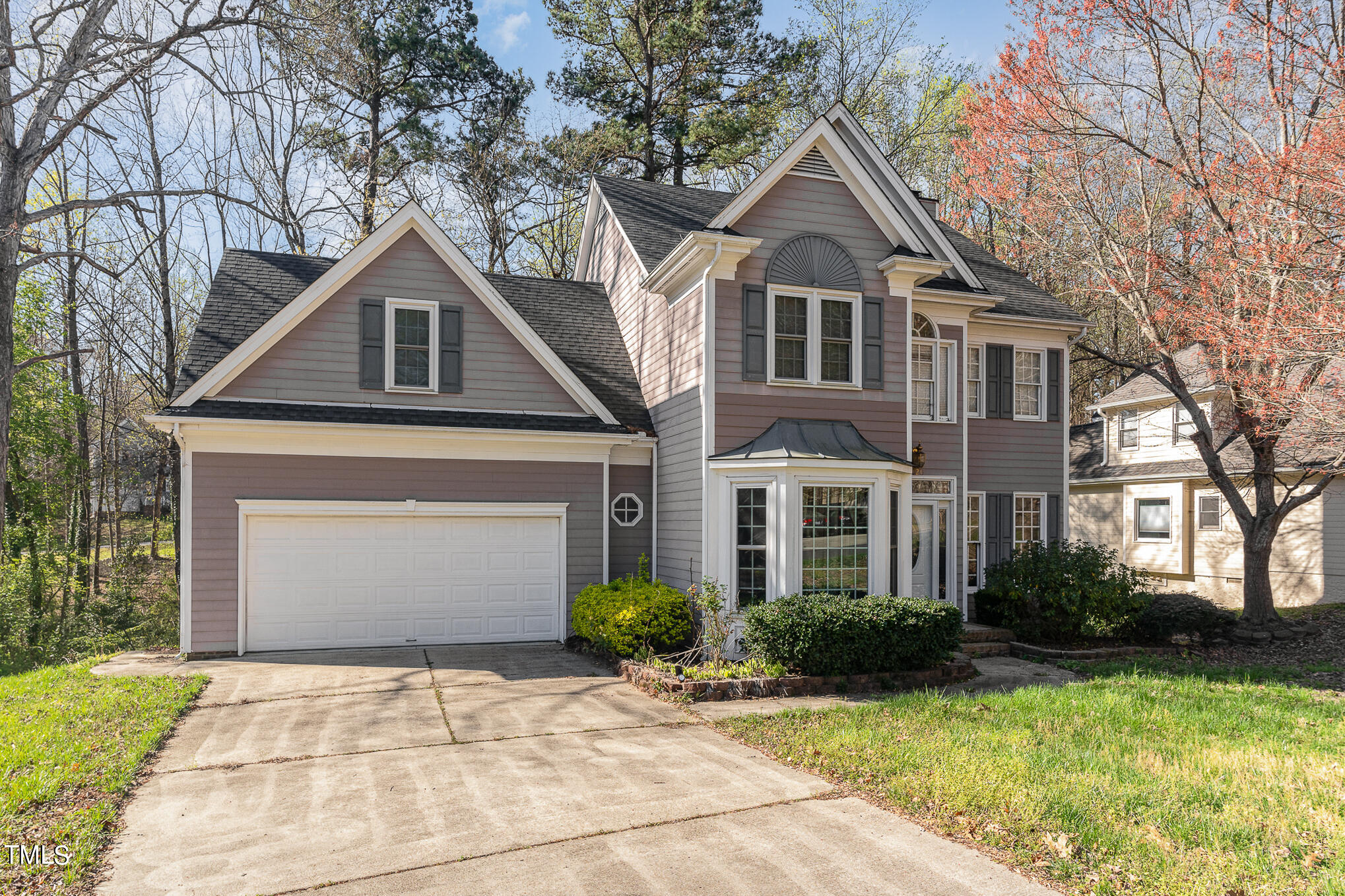6020 Bur Trail Raleigh, NC 27616 - Photo 3 of 28 a front view of a house with a yard and garage