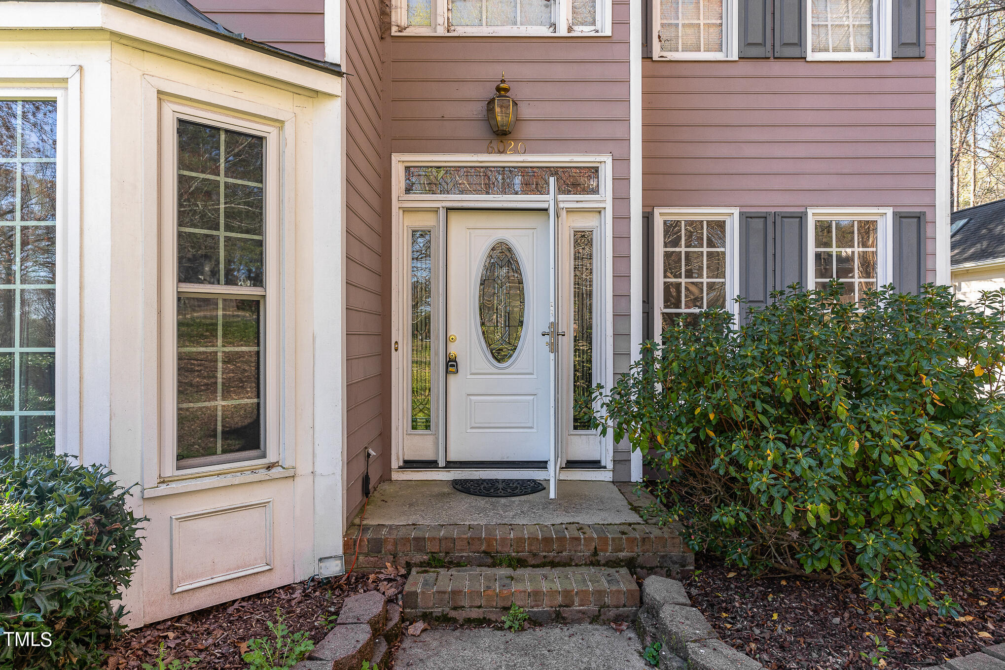 6020 Bur Trail Raleigh, NC 27616 - Photo 4 of 28 a front view of a house with a garden