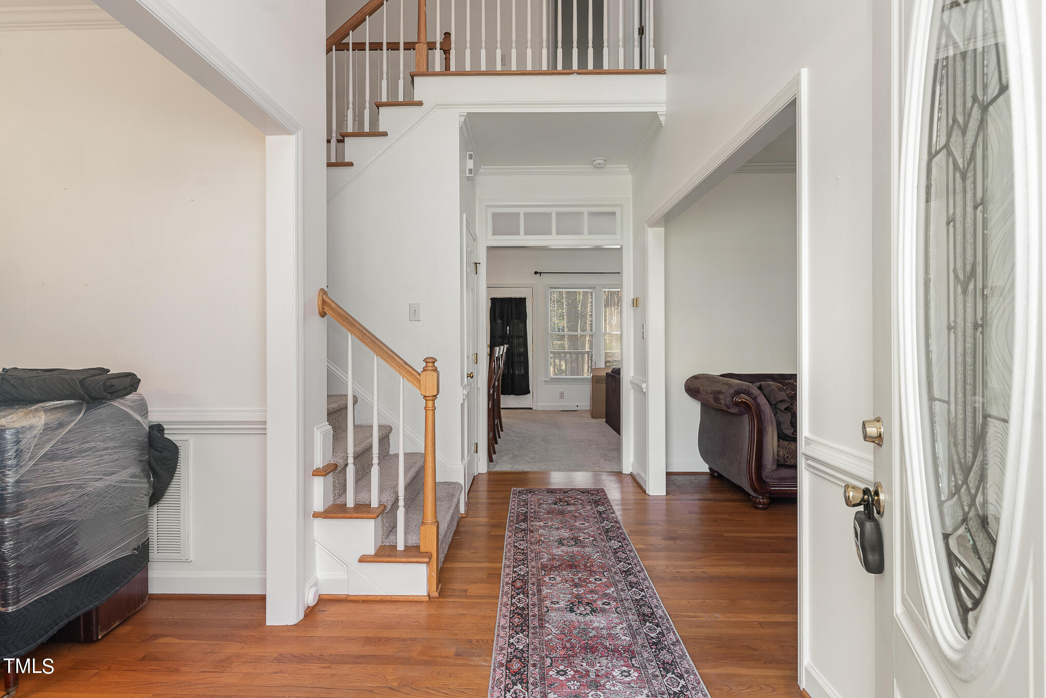 6020 Bur Trail Raleigh, NC 27616 - Photo 5 of 28 a view of a hallway with furniture and wooden floor