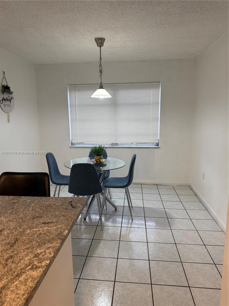 10661 Southwest 108th Avenue, Unit 2E Miami, FL 33176 - Photo 13 of 25 a kitchen with a table and chairs