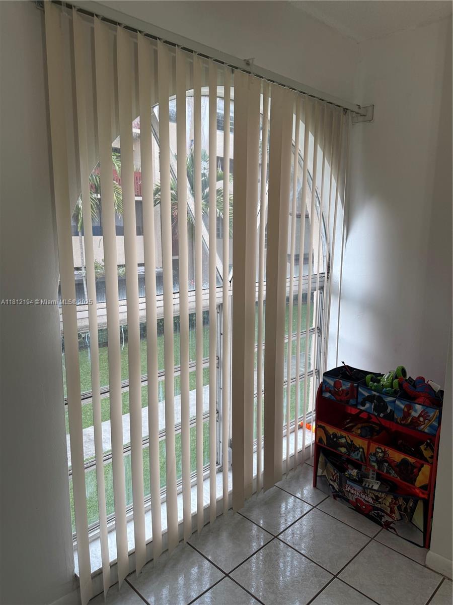 10661 Southwest 108th Avenue, Unit 2E Miami, FL 33176 - Photo 20 of 25 a utility room with multiple glass windows and furniture