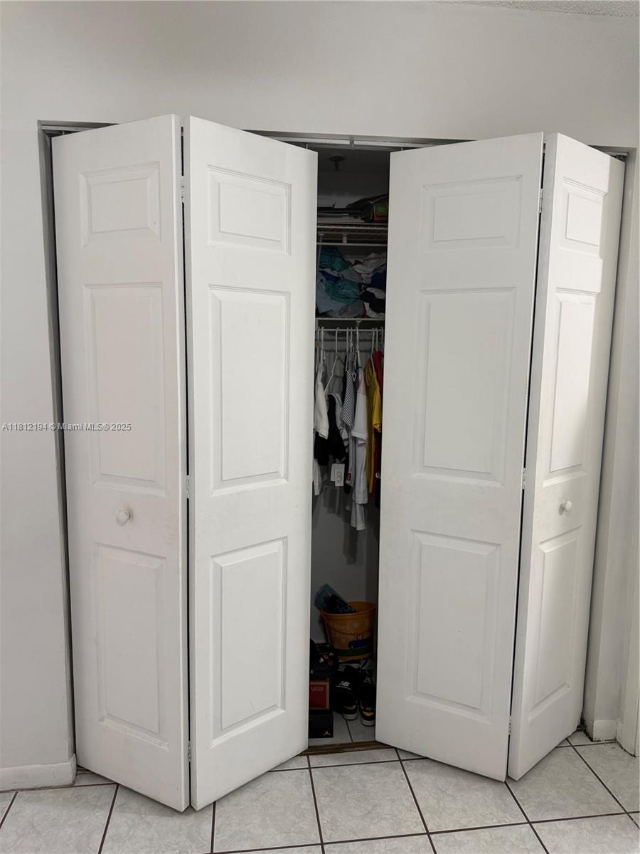 10661 Southwest 108th Avenue, Unit 2E Miami, FL 33176 - Photo 21 of 25 a view of walk in closet with empty racks
