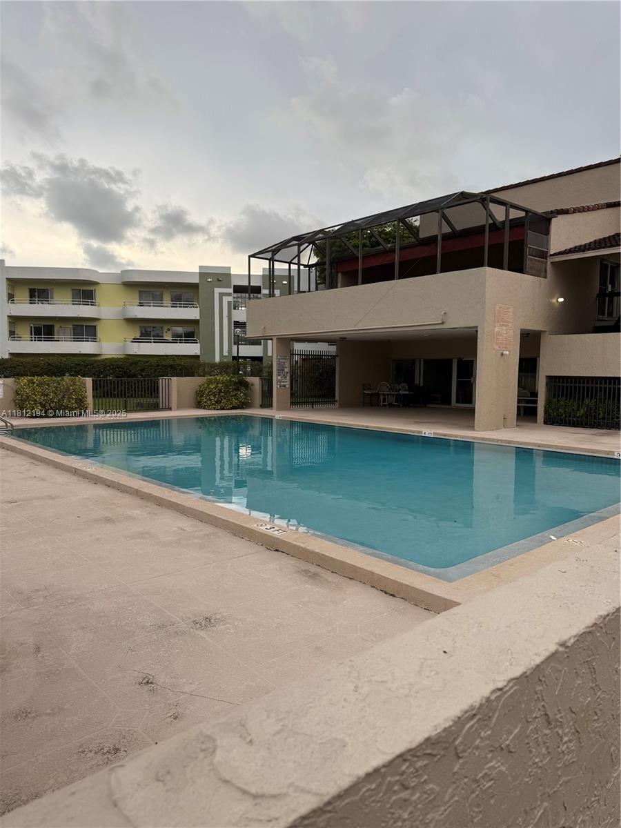 10661 Southwest 108th Avenue, Unit 2E Miami, FL 33176 - Photo 24 of 25 a view of a big yard next to a building