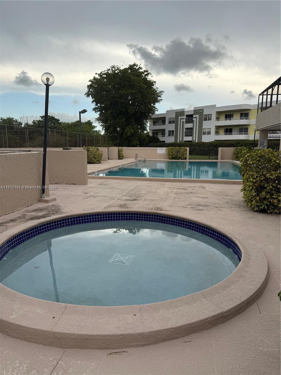 10661 Southwest 108th Avenue, Unit 2E Miami, FL 33176 - Photo 25 of 25 a view of swimming pool with a yard