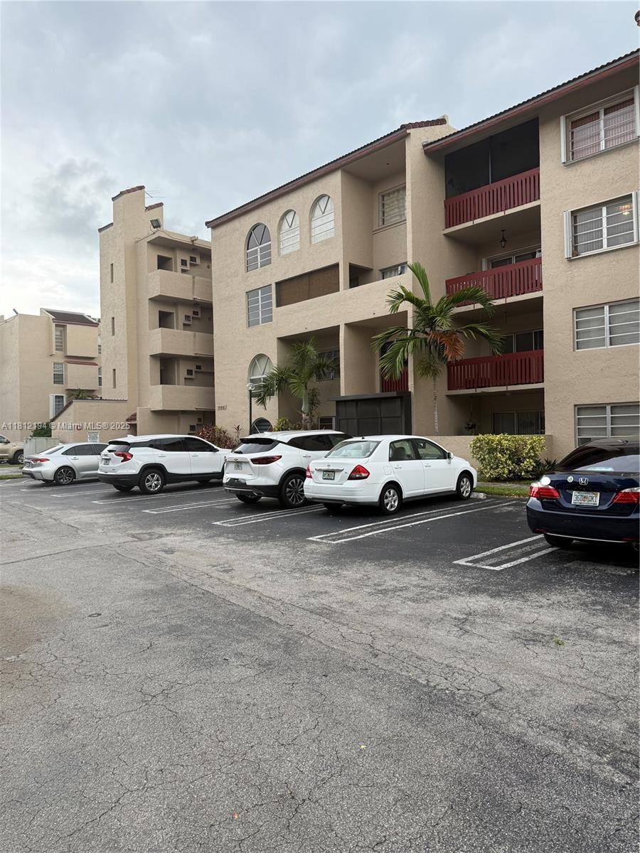 10661 Southwest 108th Avenue, Unit 2E Miami, FL 33176 - Photo 3 of 25 a car parked in front of a building