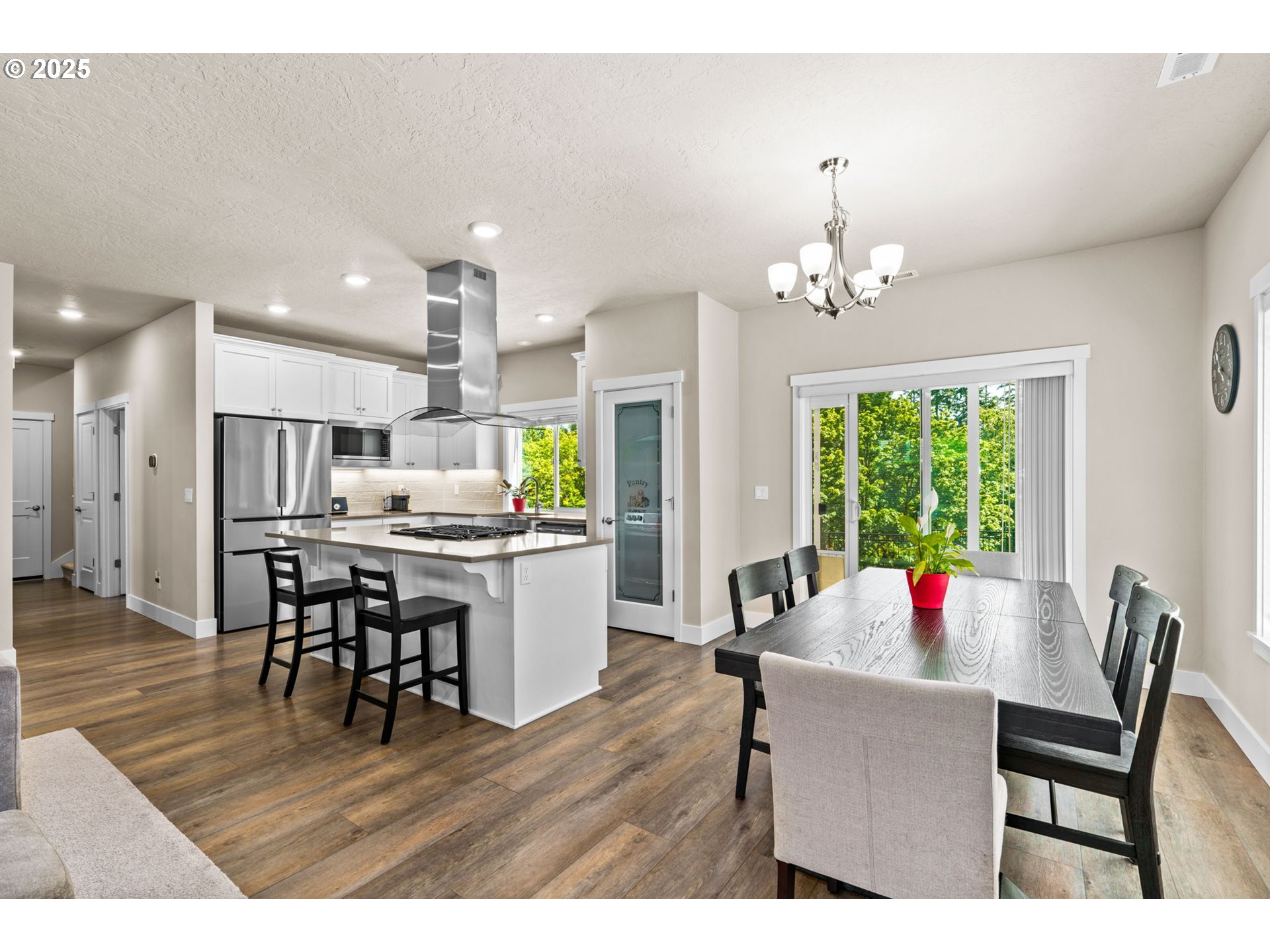 3740 Rockcress Road Eugene, OR 97403 - Photo 13 of 47 a dining room filled chandelier and wooden floor