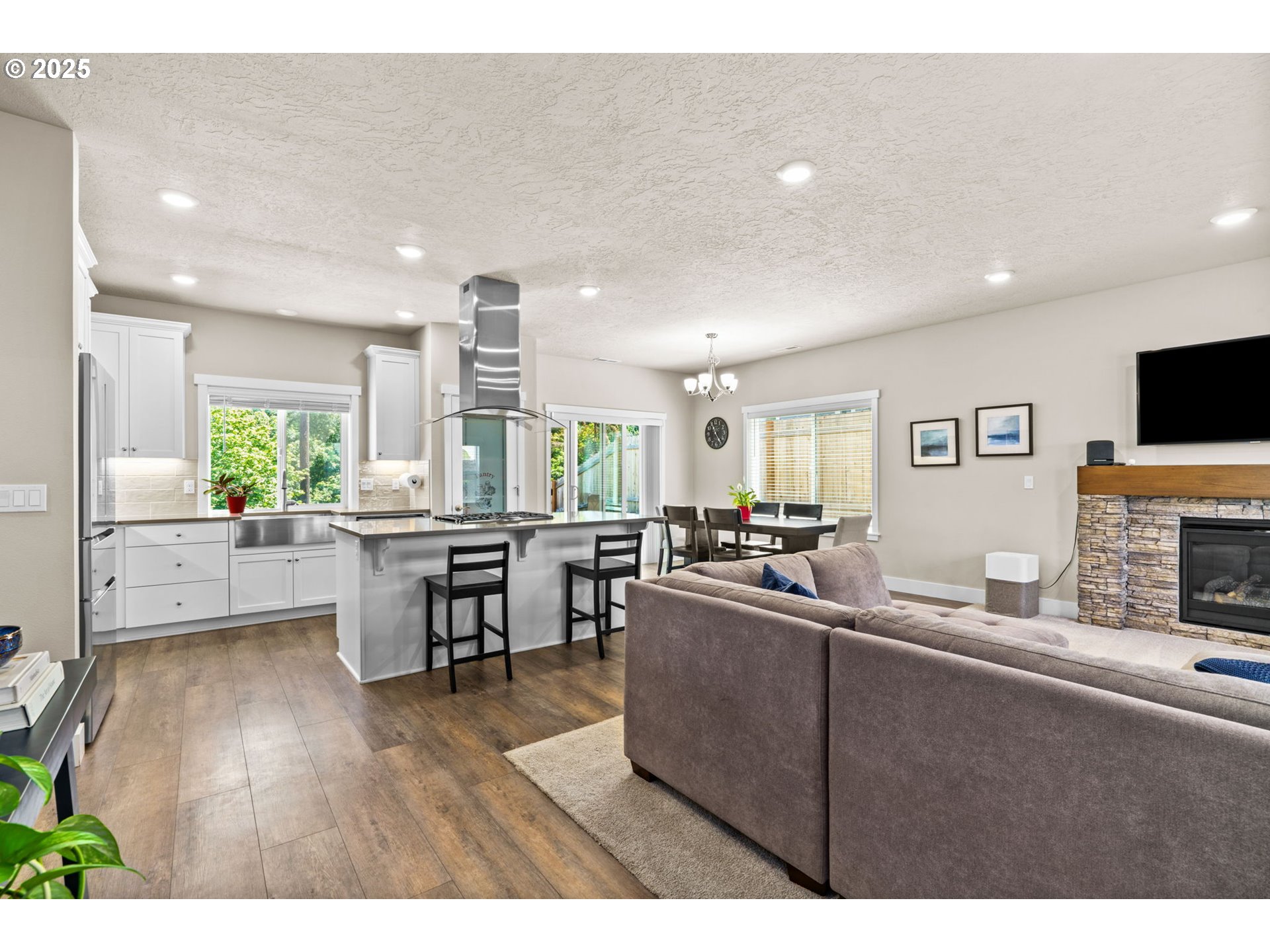 3740 Rockcress Road Eugene, OR 97403 - Photo 10 of 47 a living room with stainless steel appliances kitchen island granite countertop furniture a flat screen tv and a large window