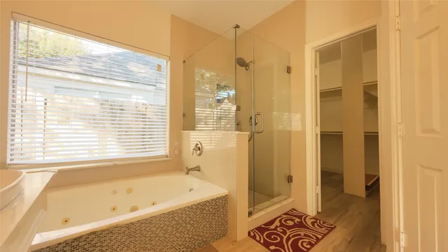a bathroom with a bathtub and a shower