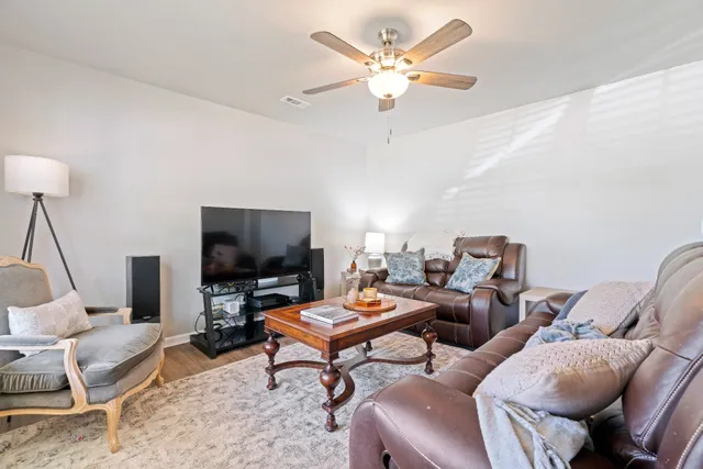 a bedroom with a bed a chandelier and a window