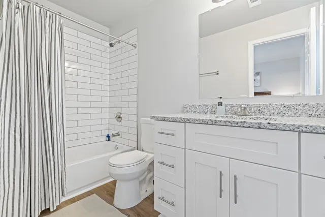 a view of a house with wooden fence