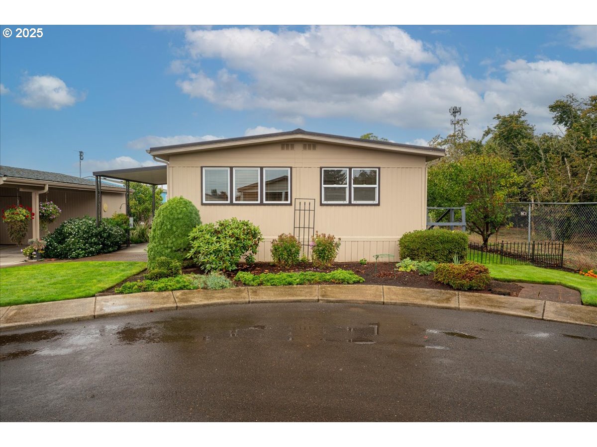 5510 Windsor Island Road North, Unit 19 Keizer, OR 97303 - Photo 2 of 32 a front view of a house with a yard and potted plants
