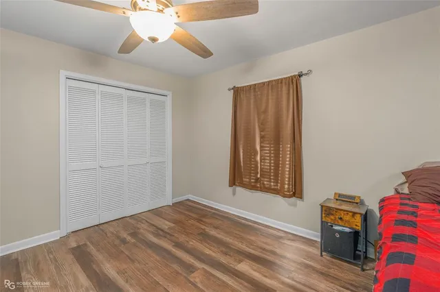 an empty room with windows and closet