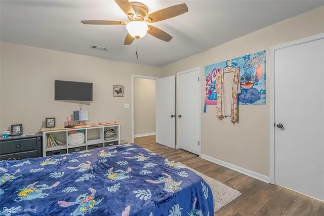 a bedroom with a bed and a desk