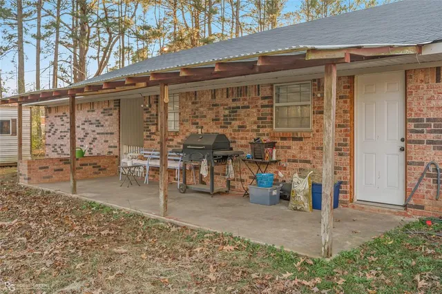 a backyard of a house with table and chairs