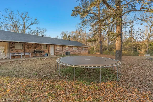 a view of a backyard with table and chairs
