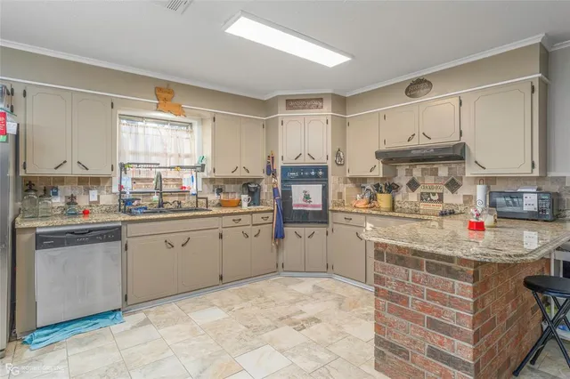a kitchen with refrigerator and cabinets