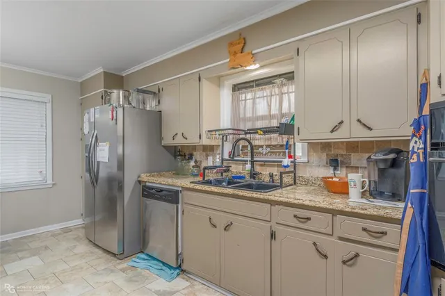 a kitchen with stainless steel appliances a refrigerator sink and cabinets