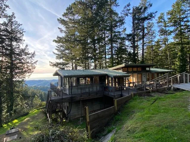 a view of a house with a yard from a balcony