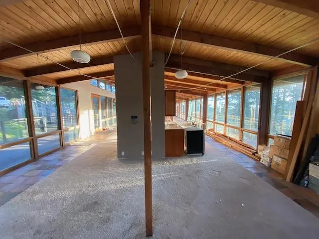 a kitchen with stainless steel appliances kitchen island granite countertop a sink and a refrigerator