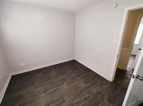 an empty room with wooden floor