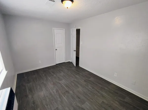 a view of a room with wooden floor