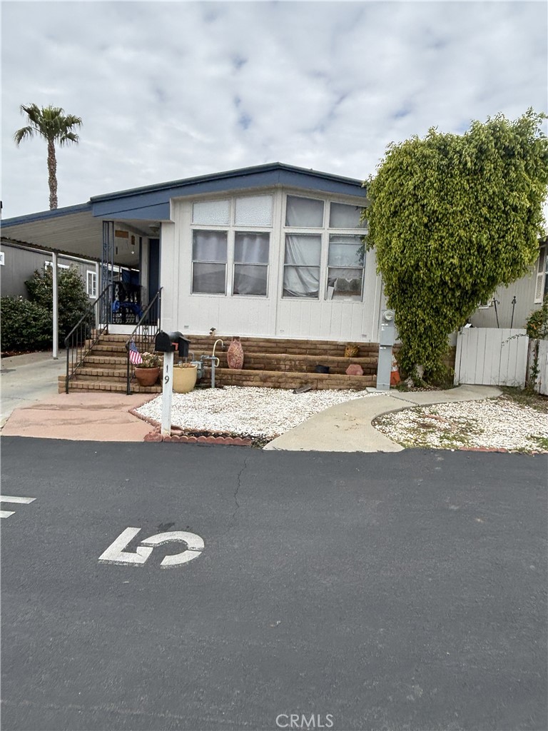 1414 West Central Avenue, Unit 19 Brea, CA 92821 - Photo 2 of 9 a view of the house with a swimming pool