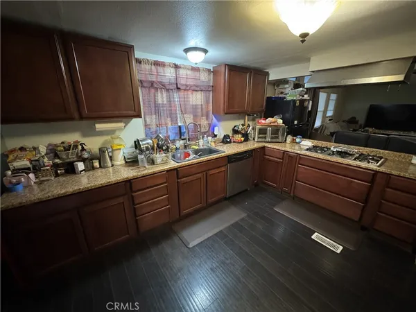 a kitchen with a sink stove and cabinets
