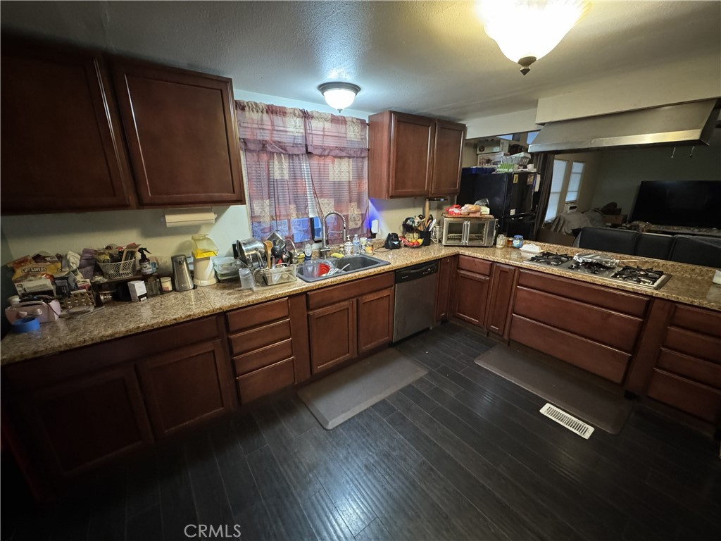 1414 West Central Avenue, Unit 19 Brea, CA 92821 - Photo 3 of 9 a kitchen with a sink stove and cabinets