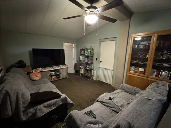 a bedroom with furniture and a flat screen tv