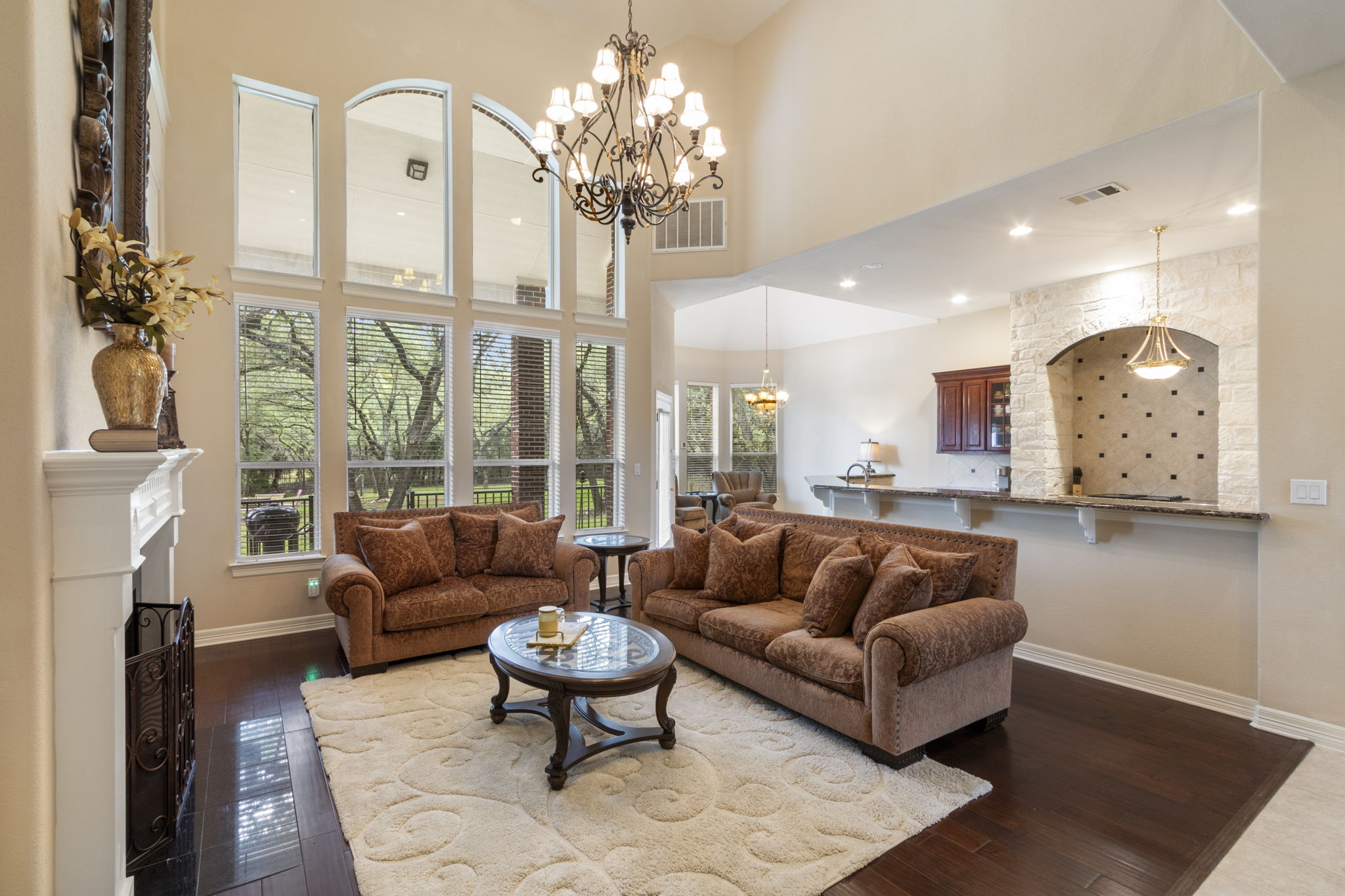 15 Sarazen Loop North Georgetown, TX 78628 - Photo 13 of 40 Living area featuring a chandelier, baseboards, dark wood-style flooring, and a high ceiling