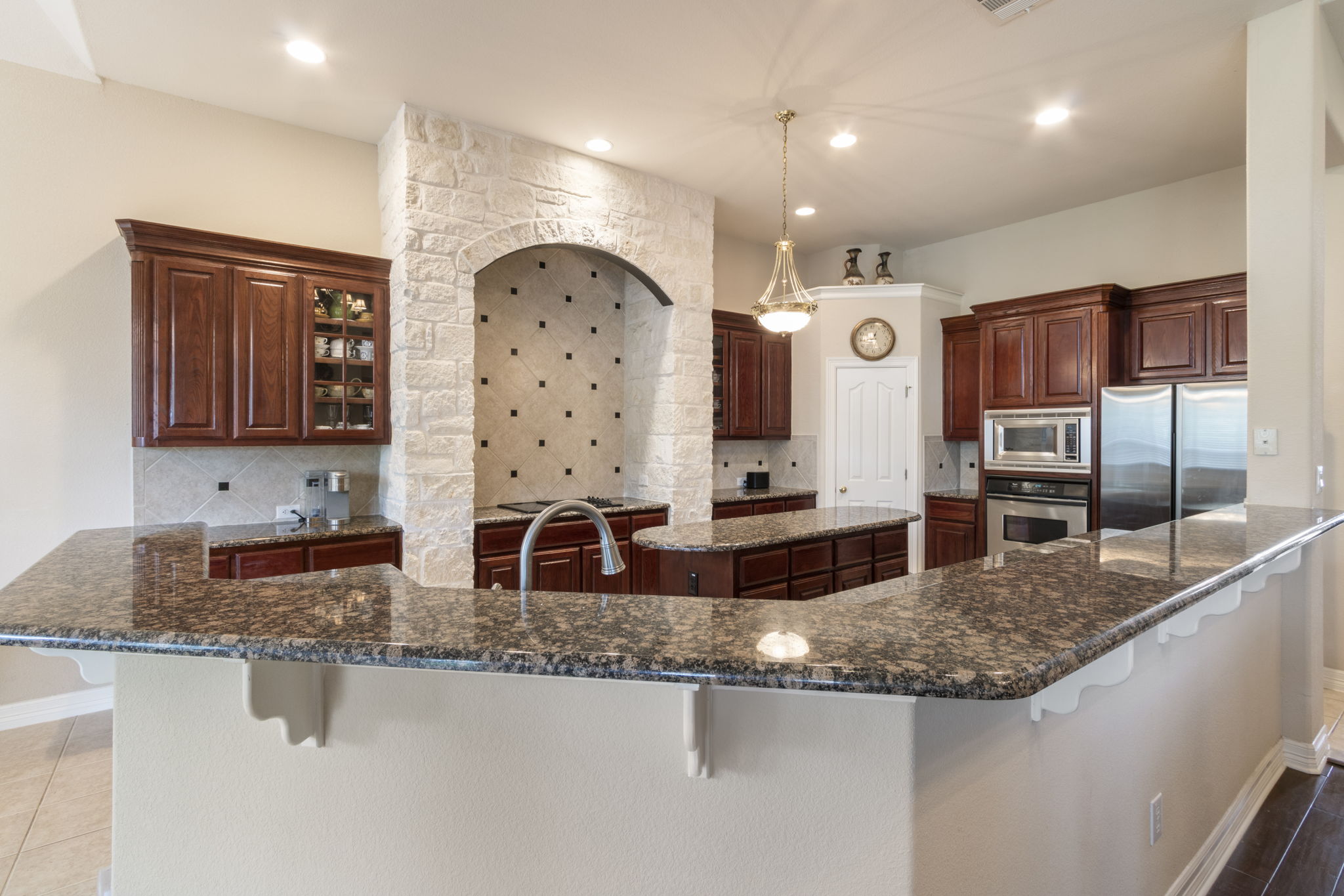 15 Sarazen Loop North Georgetown, TX 78628 - Photo 15 of 40 Kitchen featuring stainless steel appliances, a breakfast bar, tasteful backsplash, a large island, and recessed lighting