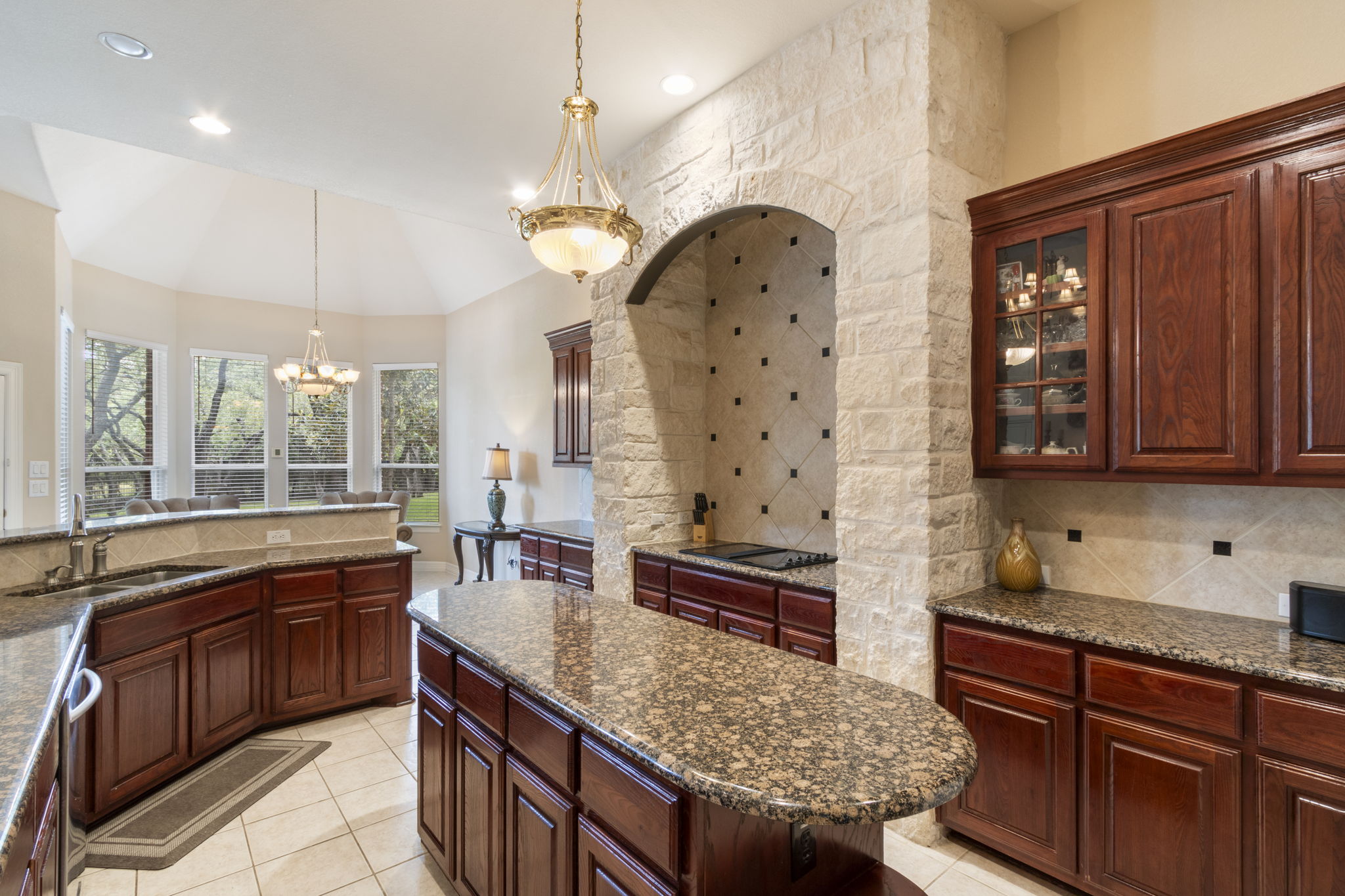 15 Sarazen Loop North Georgetown, TX 78628 - Photo 17 of 40 Kitchen featuring a sink, a chandelier, decorative backsplash, black electric cooktop, and recessed lighting