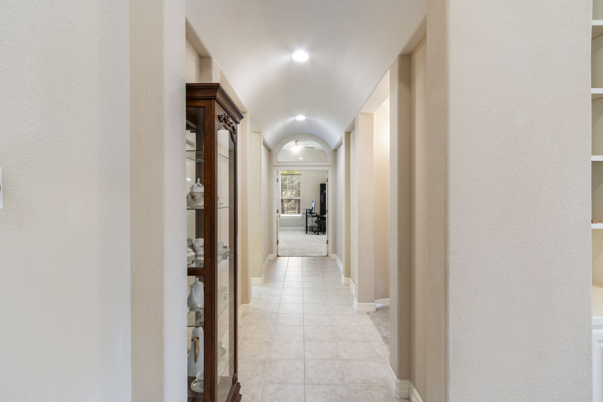 15 Sarazen Loop North Georgetown, TX 78628 - Photo 19 of 40 Hallway with light tile patterned floors and baseboards leading to 2 bedrooms