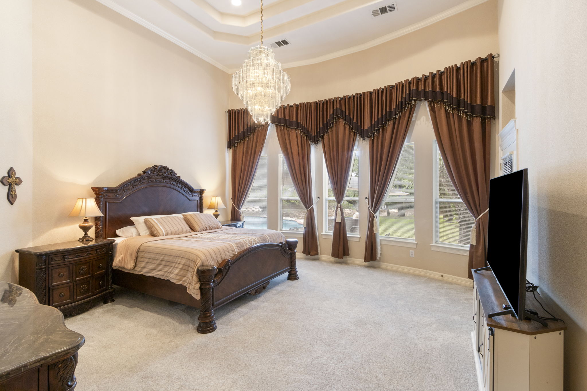 15 Sarazen Loop North Georgetown, TX 78628 - Photo 20 of 40 Bedroom featuring a chandelier, ornamental molding, carpet, a raised ceiling, and baseboards